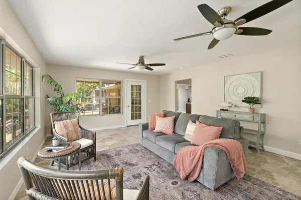 a bedroom with a bed and a chandelier fan