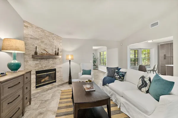 a living room with furniture and a fireplace