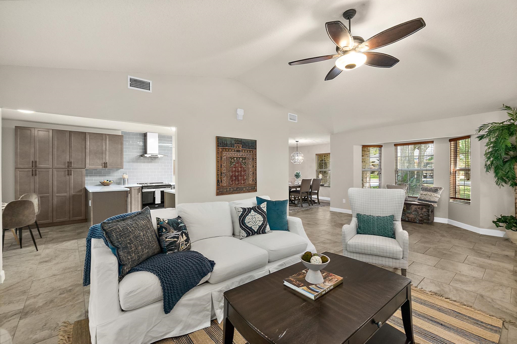 3253 Turtle Creek Road St. Augustine, FL 32086 - Photo 5 of 40 Living area featuring lofted ceiling, a ceiling fan, and light tile patterned floors