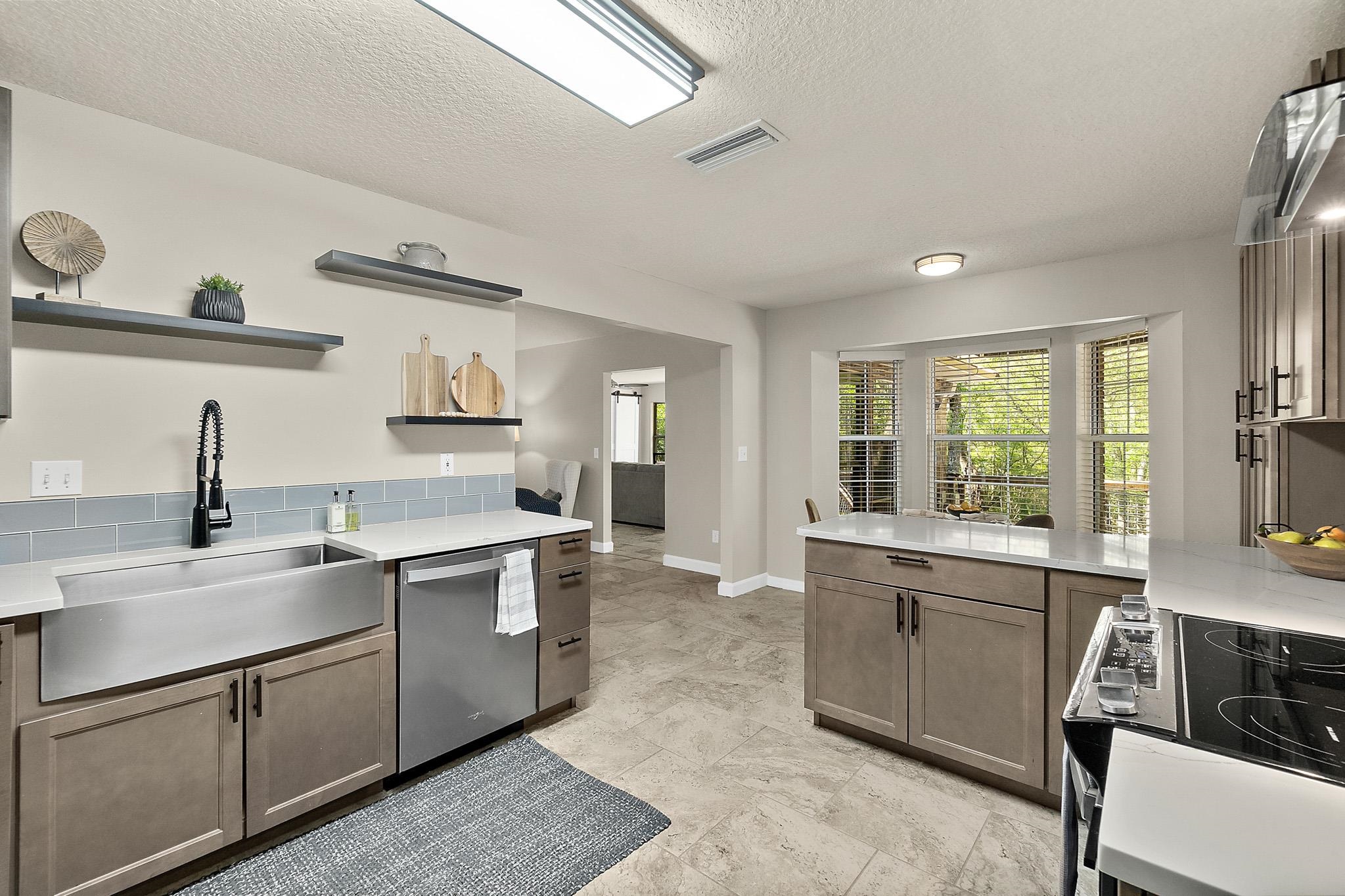 3253 Turtle Creek Road St. Augustine, FL 32086 - Photo 8 of 40 Kitchen featuring black electric range, dishwasher, a textured ceiling, light stone counters, and open shelves