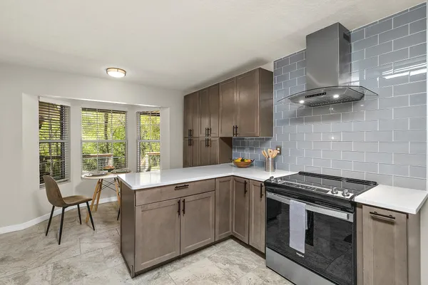 a kitchen with a sink stove and cabinets