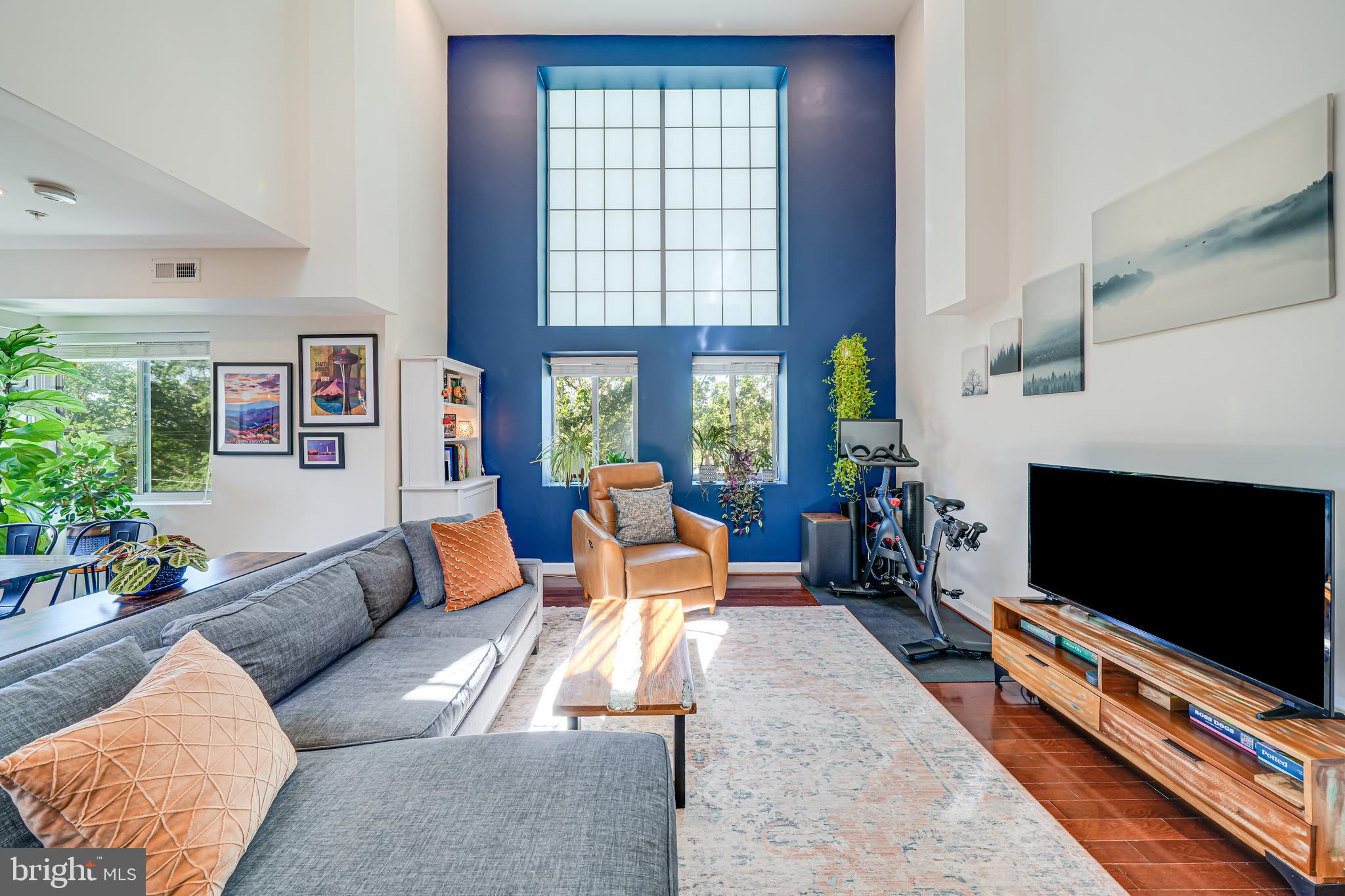 5407 9th Street Northwest, Unit 310 Washington, DC 20011 - Photo 11 of 53 a living room with furniture a flat screen tv and a fireplace