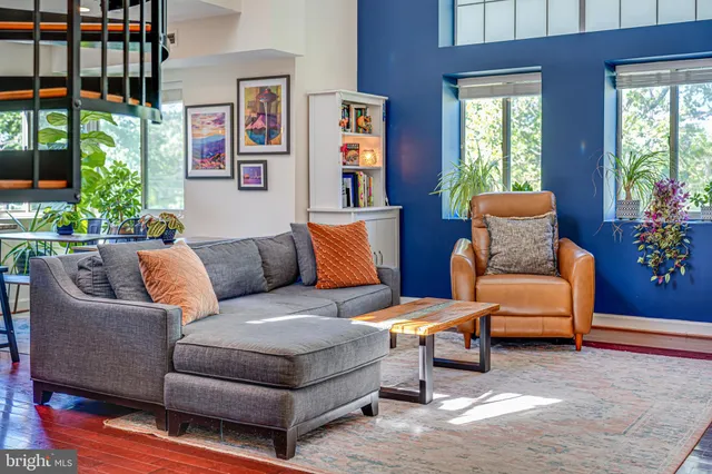 a living room with fireplace furniture and a flat screen tv