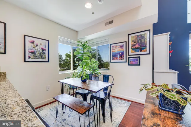 a view of a dining room with furniture window and wooden floor