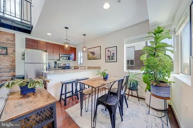 a vase of flowers sitting on a table with a window