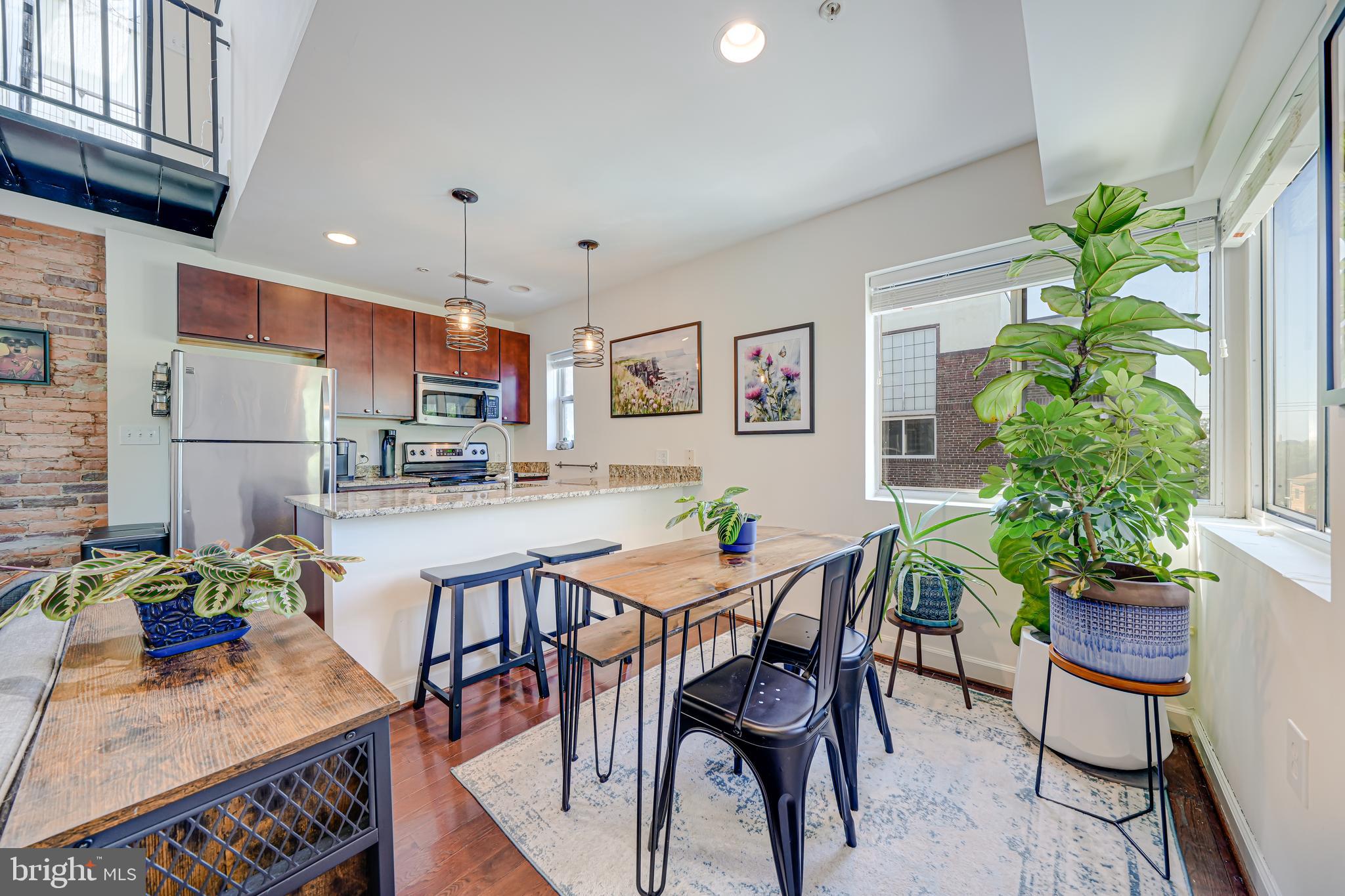 5407 9th Street Northwest, Unit 310 Washington, DC 20011 - Photo 15 of 53 a view of a dining room with furniture window and wooden floor