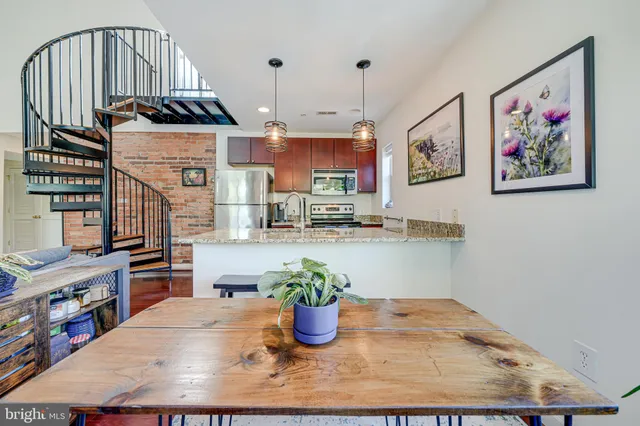 a living room with furniture and a dining table with wooden floor