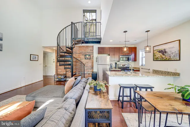 a kitchen with stainless steel appliances granite countertop a sink and a refrigerator
