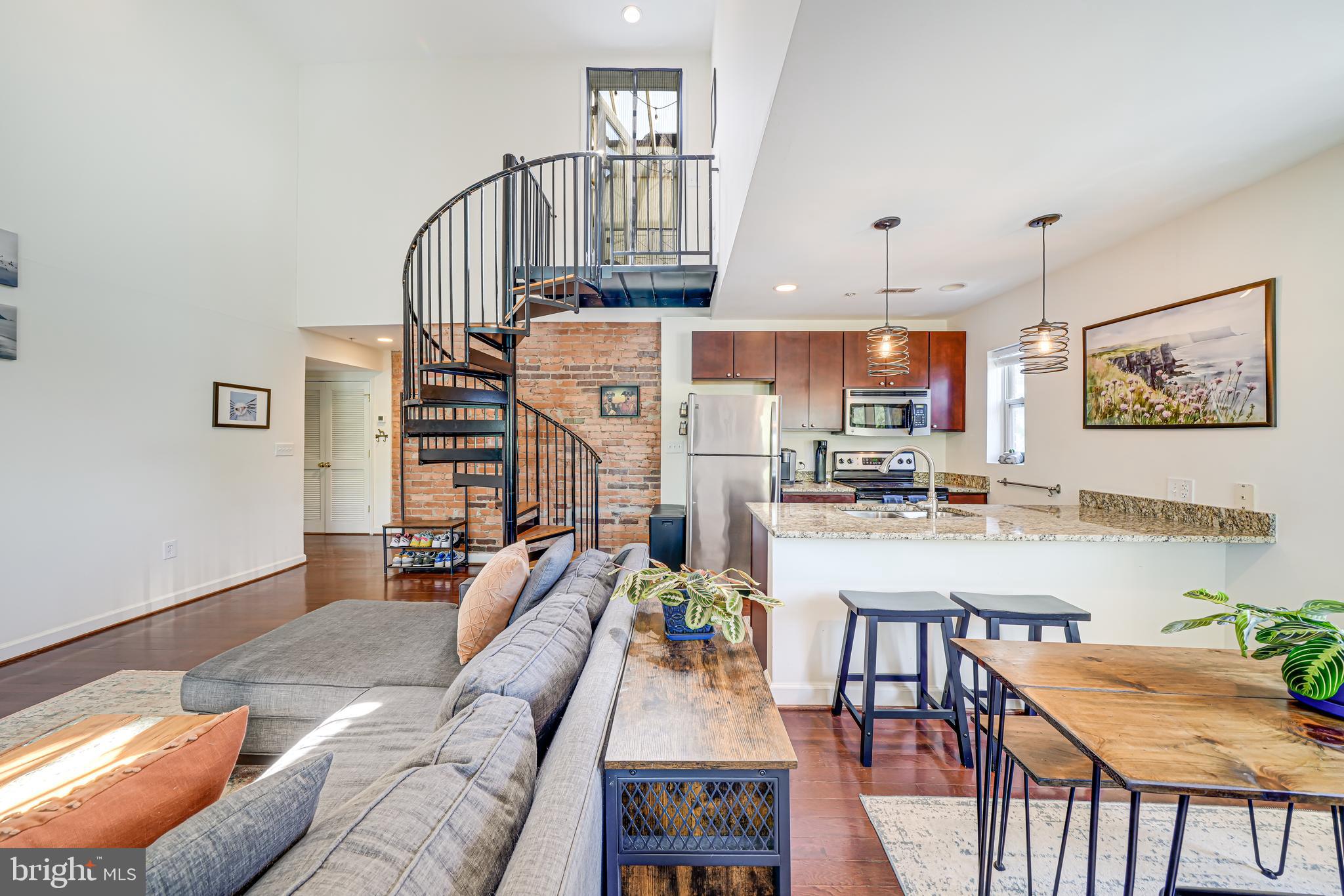 5407 9th Street Northwest, Unit 310 Washington, DC 20011 - Photo 18 of 53 a living room with furniture and a dining table with wooden floor