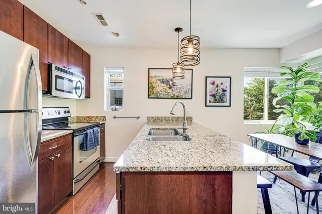 a kitchen that has a sink and a stove