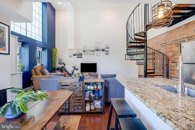 a living room with furniture a fireplace and a table