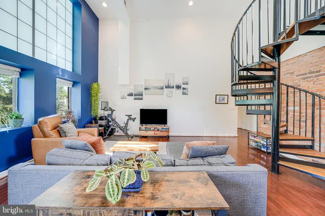 a living room with fireplace furniture and a window