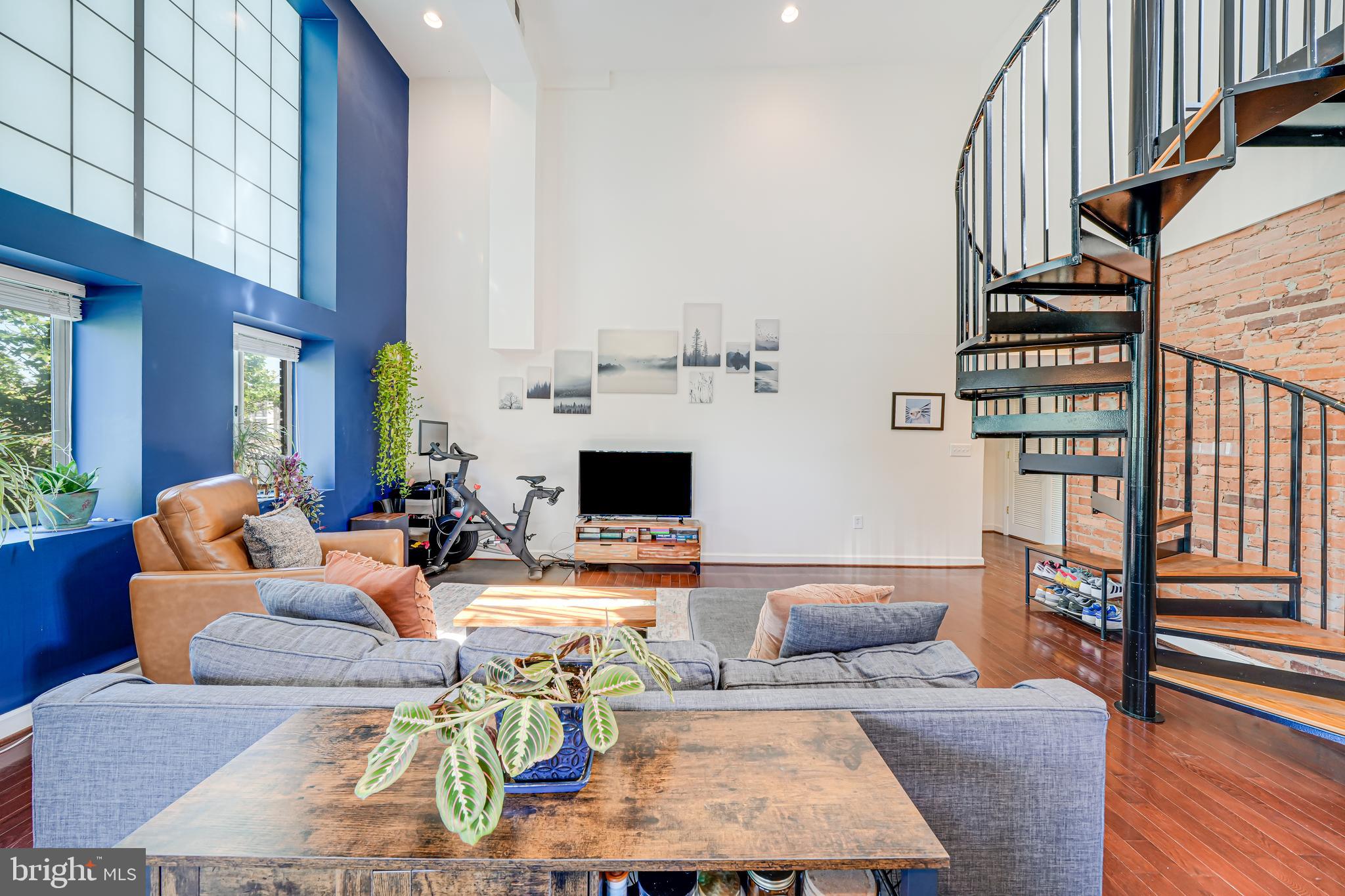 5407 9th Street Northwest, Unit 310 Washington, DC 20011 - Photo 26 of 53 a living room with furniture a fireplace and a table