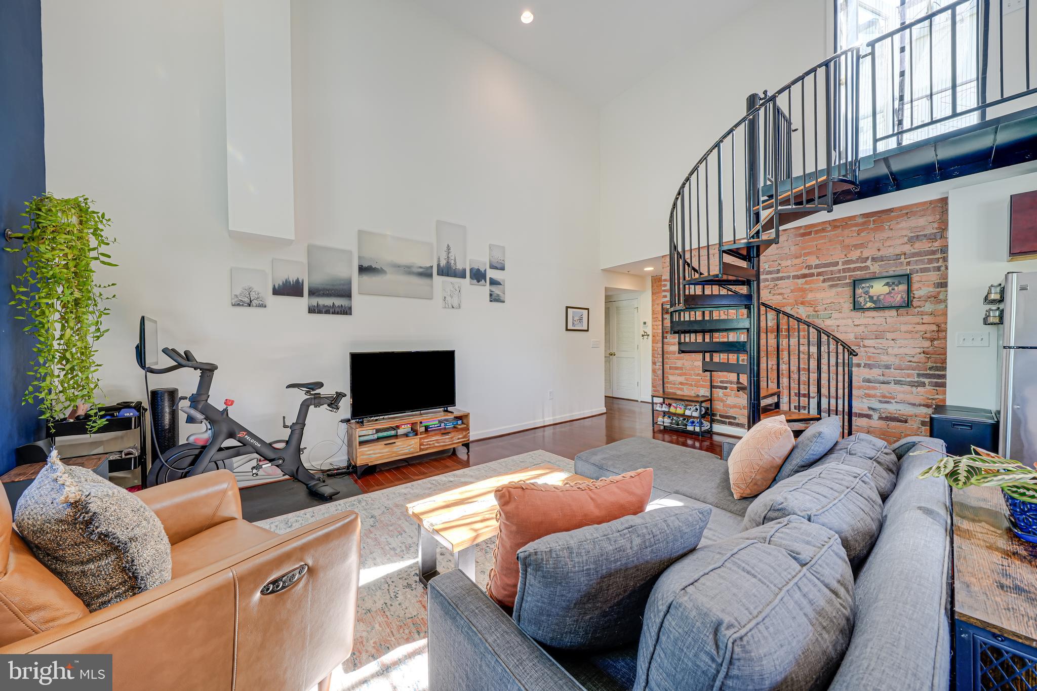 5407 9th Street Northwest, Unit 310 Washington, DC 20011 - Photo 28 of 53 a living room with furniture a flat screen tv and a window