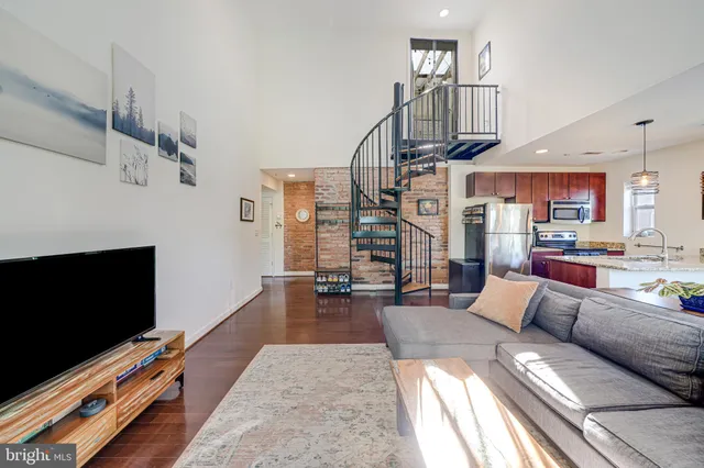 a living room with fireplace furniture and a flat screen tv