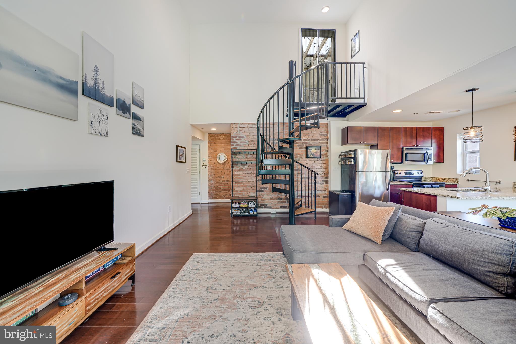 5407 9th Street Northwest, Unit 310 Washington, DC 20011 - Photo 29 of 53 a living room with furniture and a flat screen tv