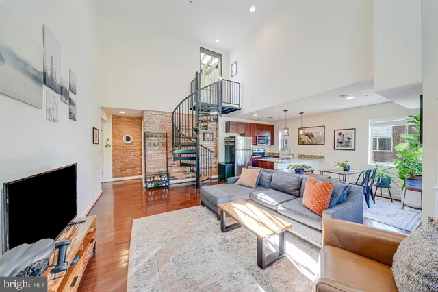 a living room with furniture wooden floor and a book shelf