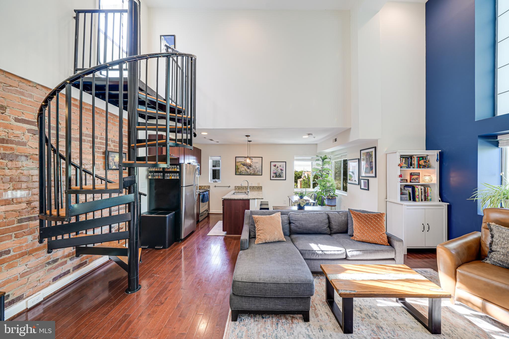 5407 9th Street Northwest, Unit 310 Washington, DC 20011 - Photo 31 of 53 a living room with furniture wooden floor and a book shelf