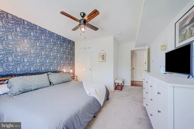 a bed room with a bed and a potted plant