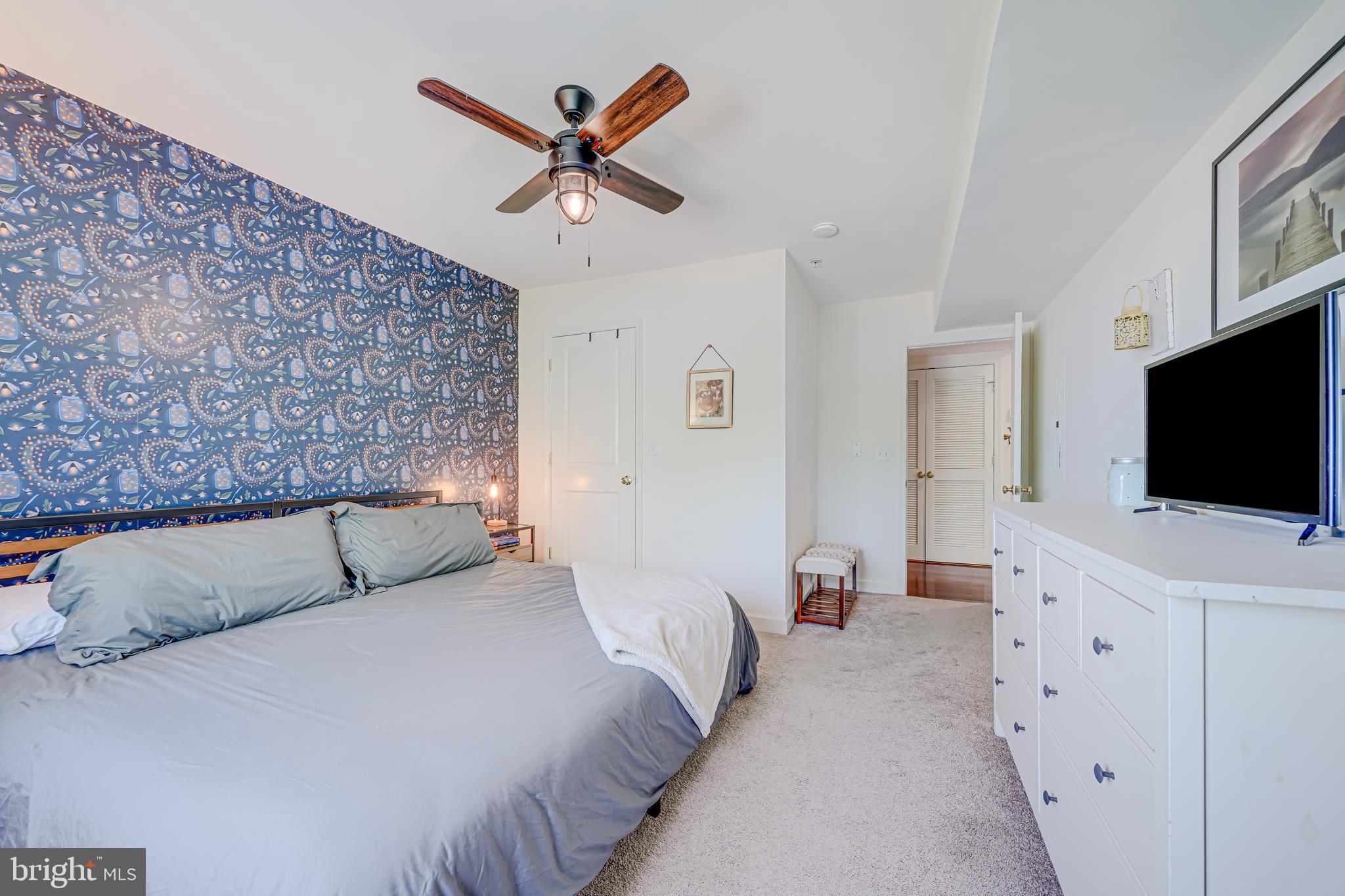 5407 9th Street Northwest, Unit 310 Washington, DC 20011 - Photo 36 of 53 a bedroom with a bed and a flat screen tv