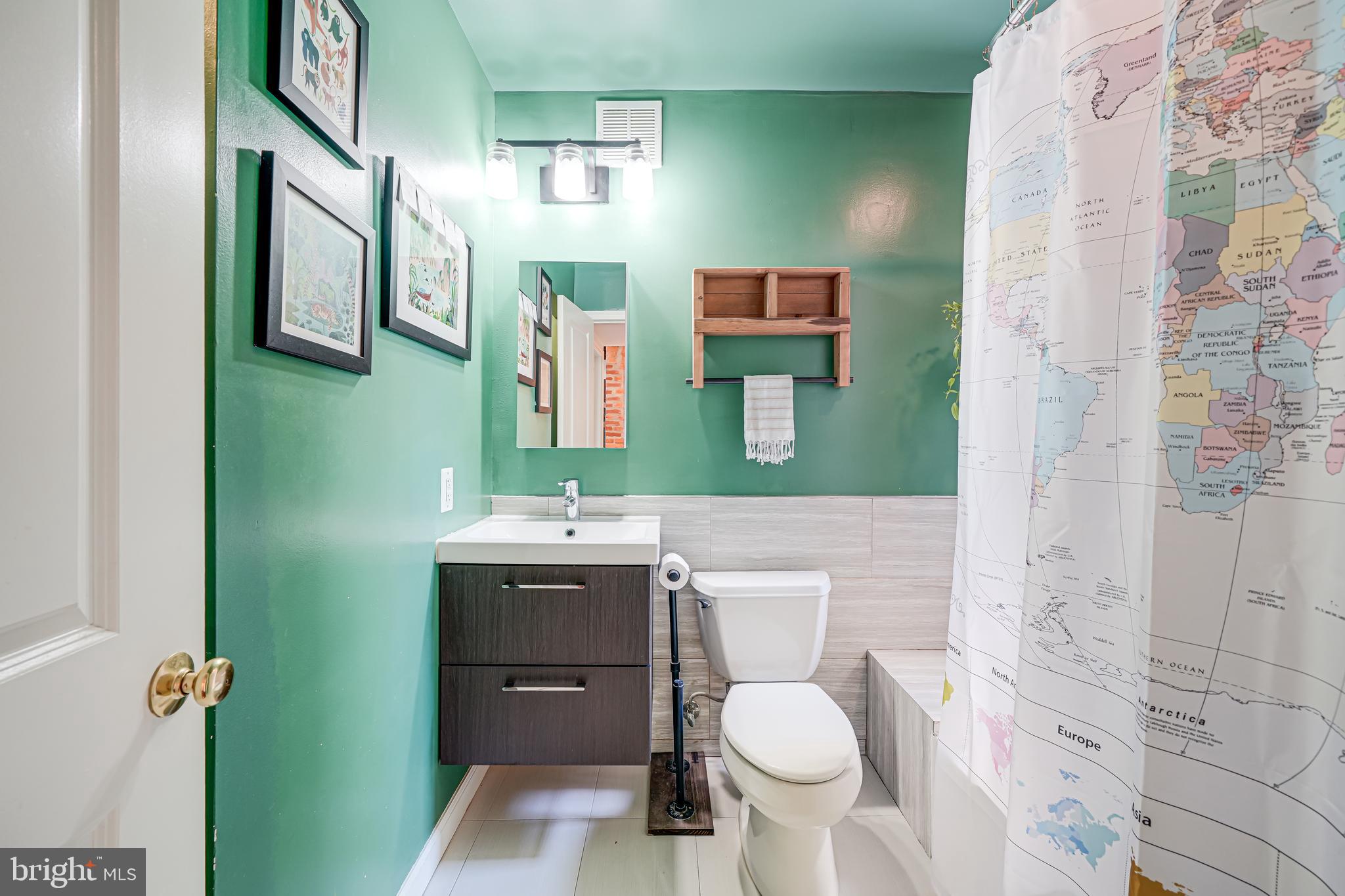 5407 9th Street Northwest, Unit 310 Washington, DC 20011 - Photo 41 of 53 a bathroom with a toilet sink vanity and mirror