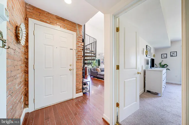 a living room with furniture fireplace and a large window