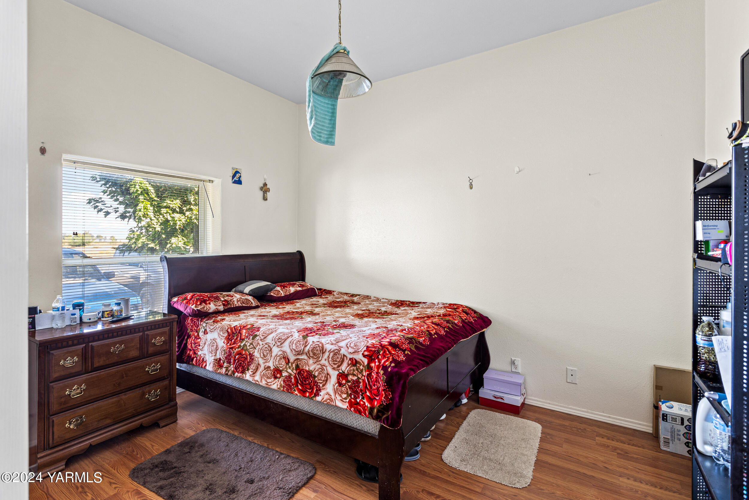 1649 Progressive Road Wapato, WA 98951 - Photo 16 of 30 a bedroom with a bed and wooden floor