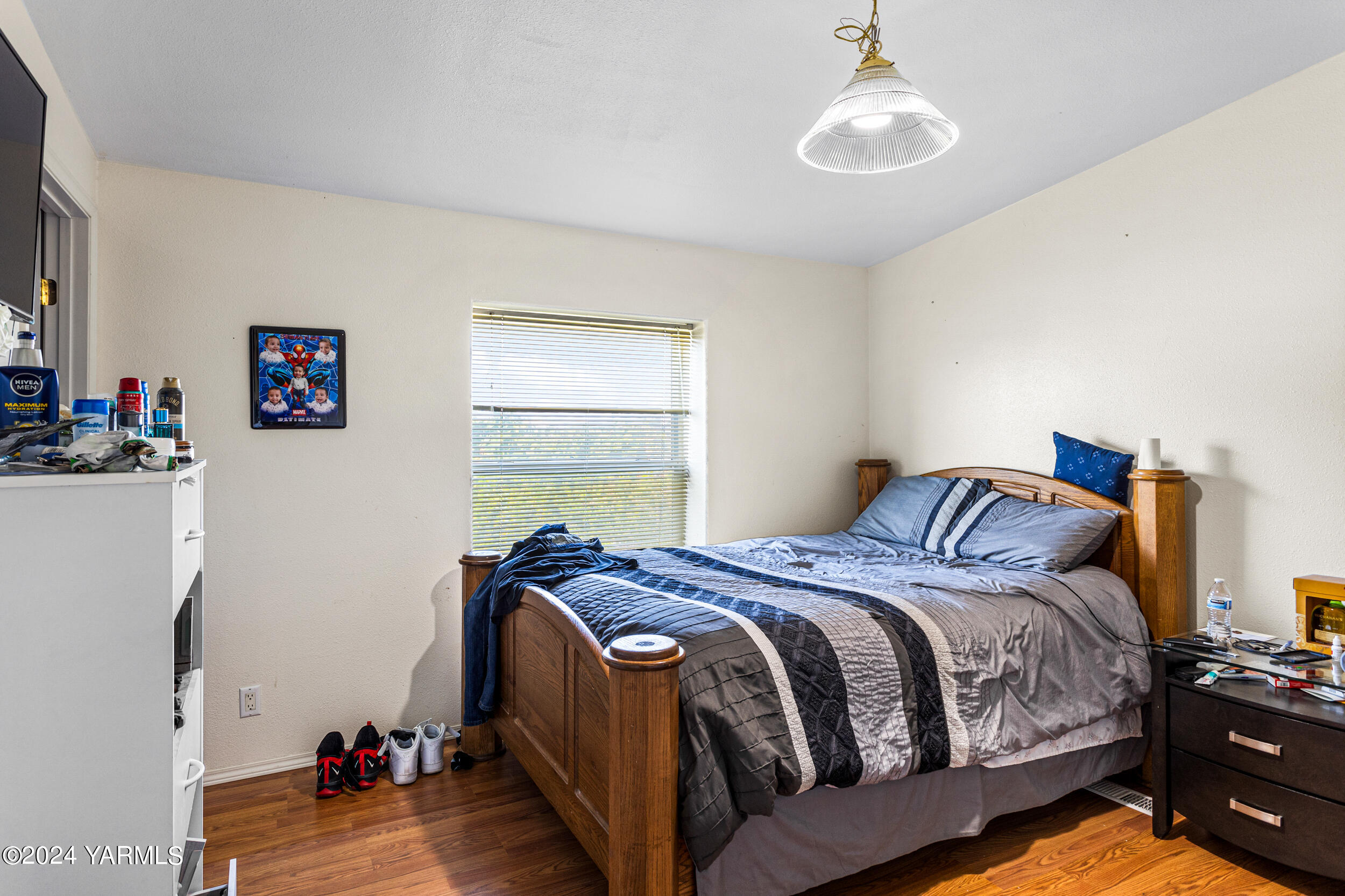1649 Progressive Road Wapato, WA 98951 - Photo 17 of 30 a bedroom with a bed and wooden floor