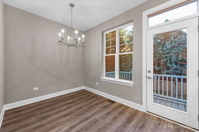 a view of a balcony with wooden floor and fence