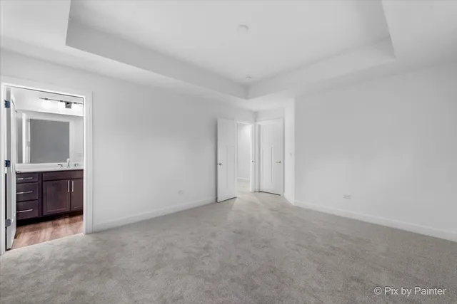 a bathroom with a sink a toilet and a large mirror