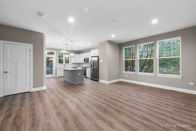 a view of a livingroom with wooden floor and flat screen tv