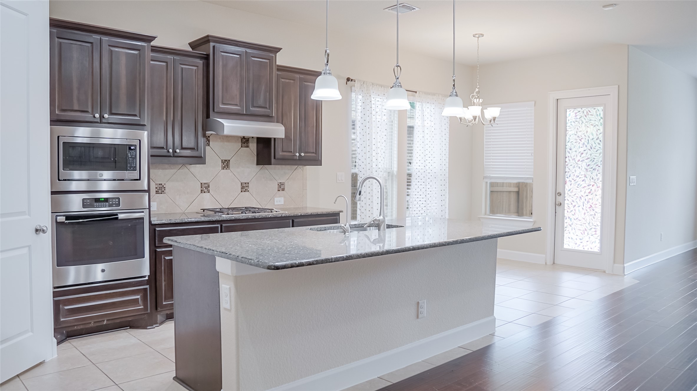 184 Fort Cobb Way Georgetown, TX 78628 - Photo 16 of 33 a kitchen with kitchen island granite countertop a sink cabinets and stainless steel appliances