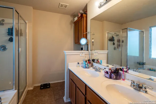 a bathroom with a sink double vanity and a mirror