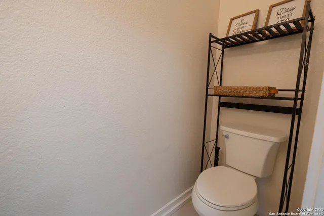 a white toilet sitting next to a bathroom sink