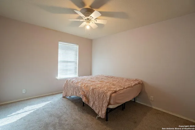 a bed sitting in a bedroom next to a window