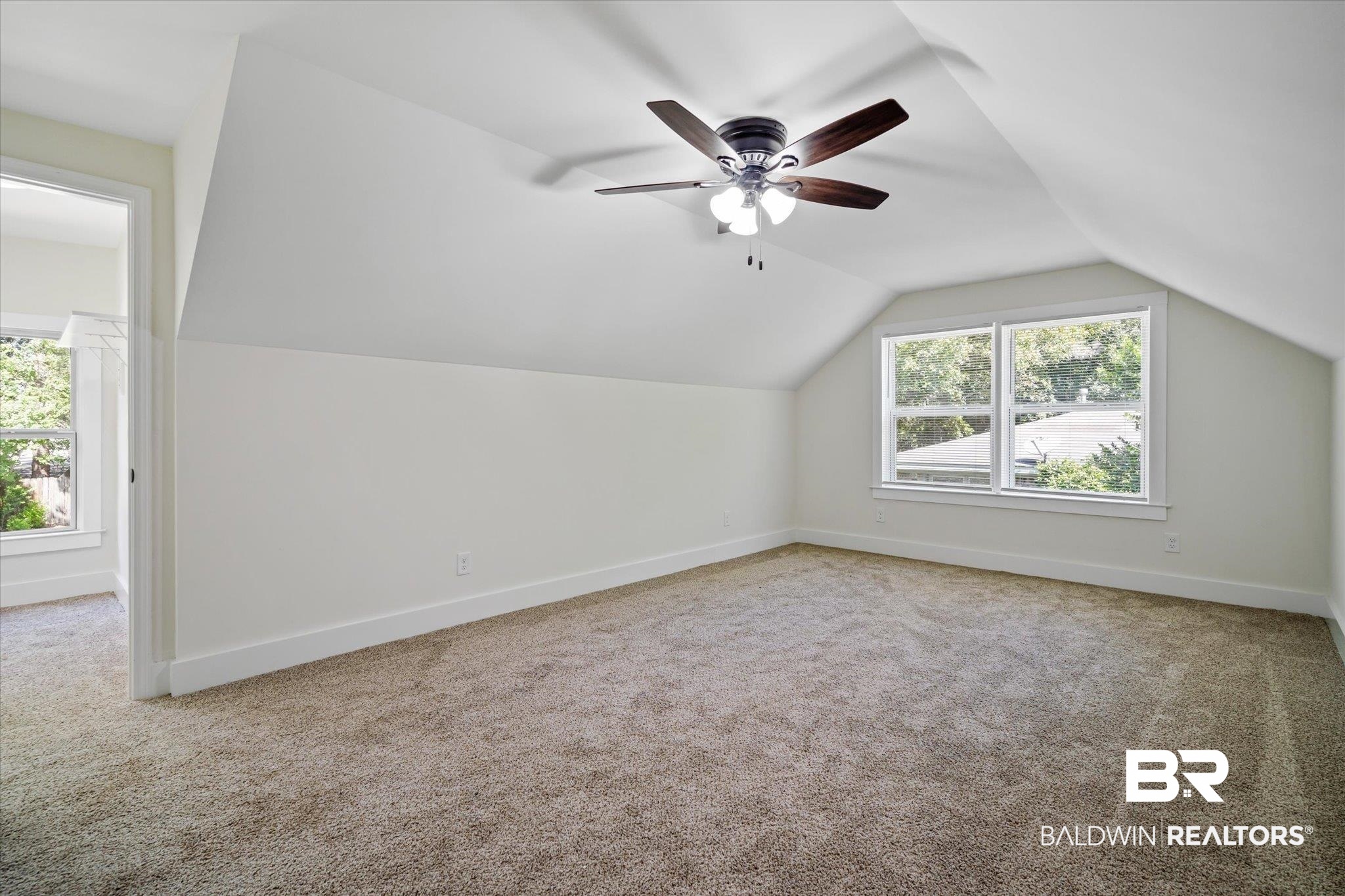 308 Byron Avenue West Mobile, AL 36609 - Photo 22 of 33 Additional living space featuring lofted ceiling, a healthy amount of sunlight, ceiling fan, and carpet flooring