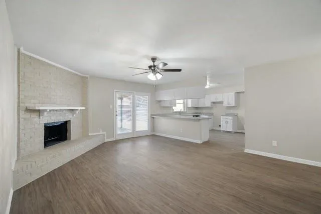 a view of a kitchen with a sink dishwasher and a fireplace