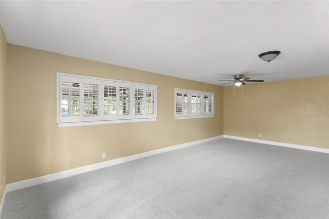 a bedroom with a large bed and a potted plant