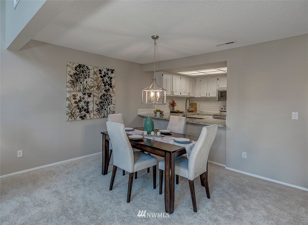 7501 Old Redmond Road, Unit 414 Redmond, WA 98052 - Photo 5 of 22 a view of a dining room with furniture window and wooden floor