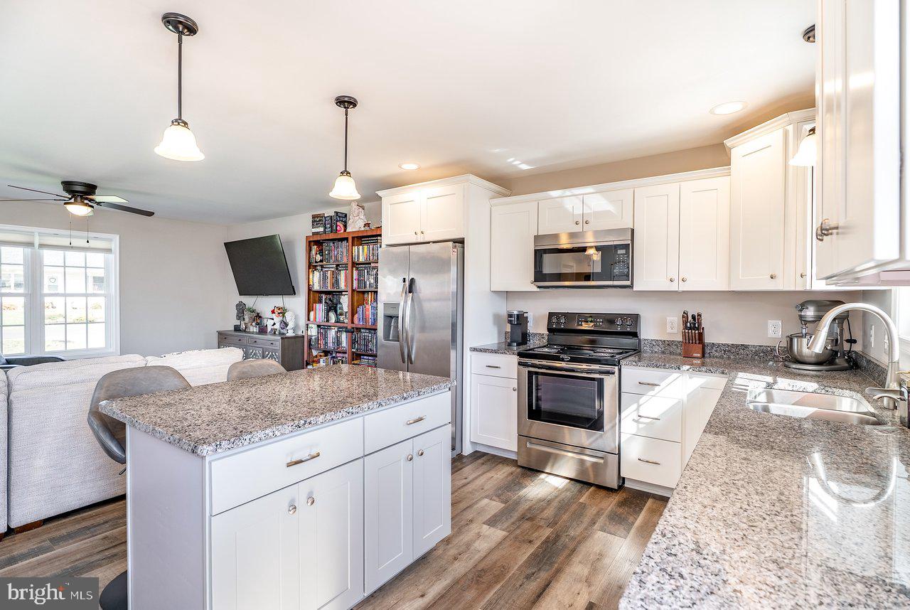 107 8th Street Grottoes, VA 24441 - Photo 16 of 45 a kitchen with stainless steel appliances granite countertop a sink stove and refrigerator
