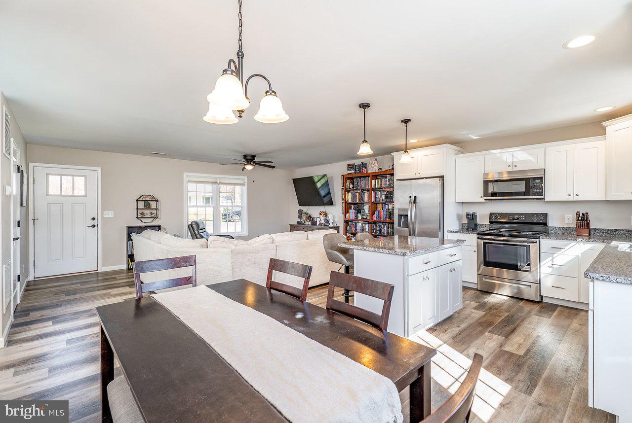 107 8th Street Grottoes, VA 24441 - Photo 21 of 45 a living room with stainless steel appliances kitchen island granite countertop furniture a rug kitchen view and a chandelier