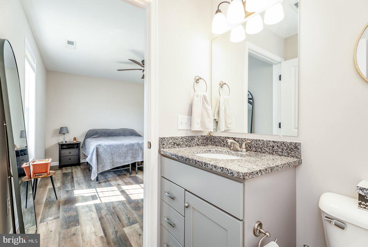 107 8th Street Grottoes, VA 24441 - Photo 27 of 45 a en suite bathroom with a granite countertop sink and a mirror