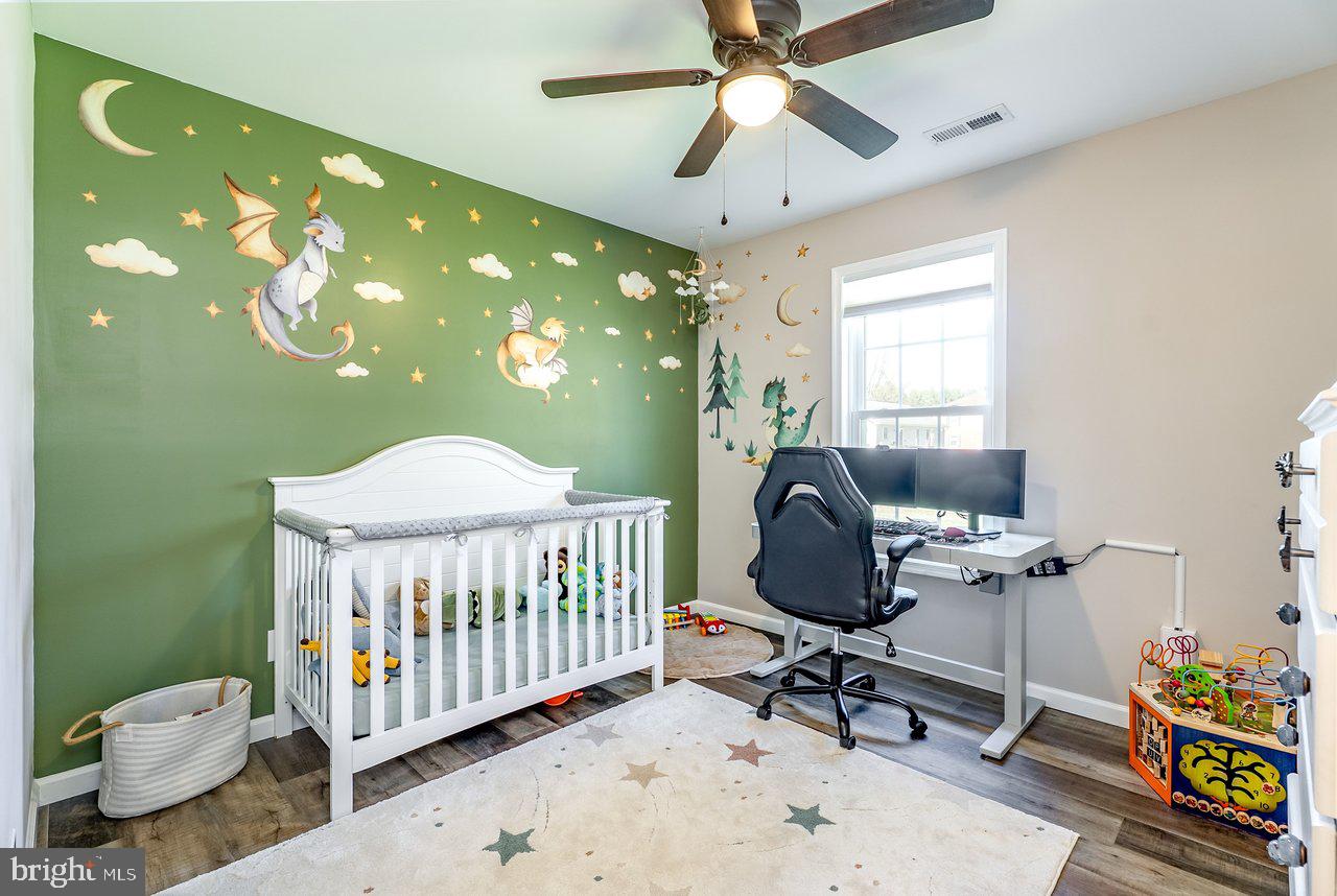 107 8th Street Grottoes, VA 24441 - Photo 29 of 45 a bedroom with a bed and a chandelier