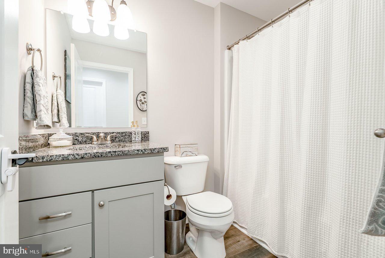107 8th Street Grottoes, VA 24441 - Photo 34 of 45 a bathroom with a granite countertop sink toilet and mirror