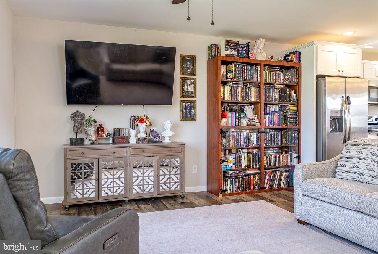 107 8th Street Grottoes, VA 24441 - Photo 6 of 45 a living room with lots of furniture and a book shelf