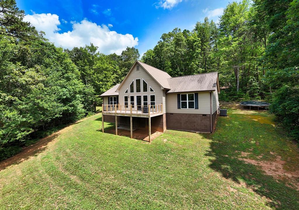 a view of a house with a yard balcony and sitting area