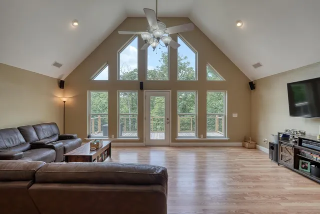 a kitchen with a refrigerator a stove a sink a dining table and chairs