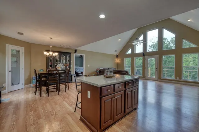 a view of a dining room with furniture and chandelier
