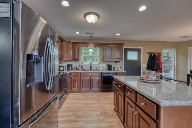a large kitchen with a table and chairs