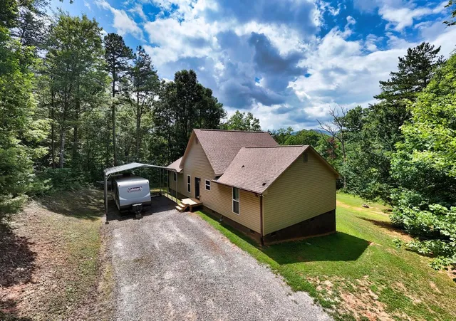 a view of a house with a yard and sitting area
